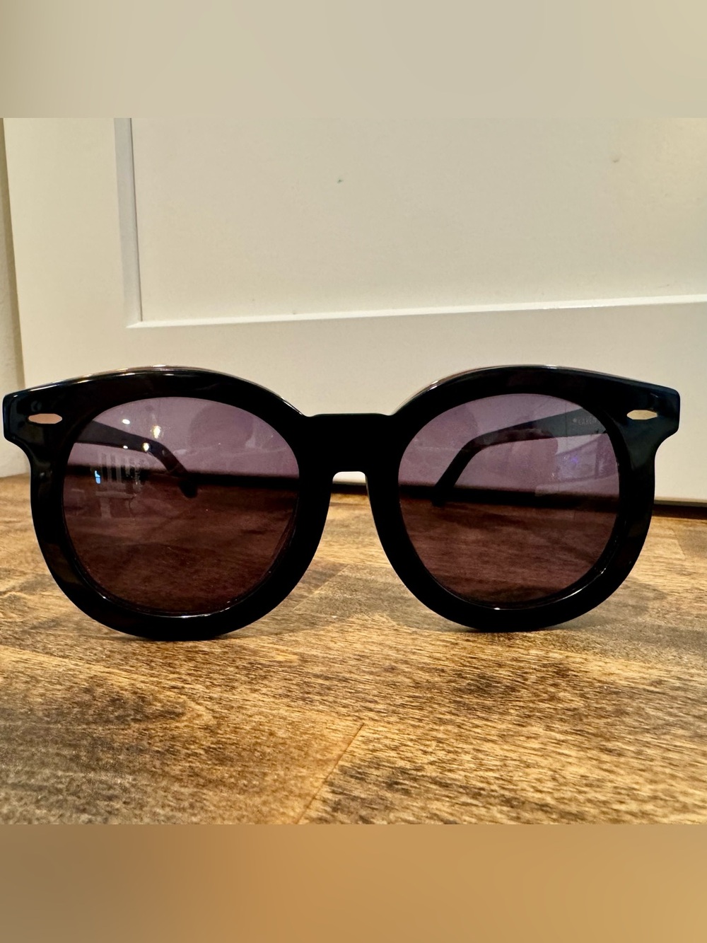 Karen Walker Black Round Sunglasses with Gold Detail and Purple Tint Lenses